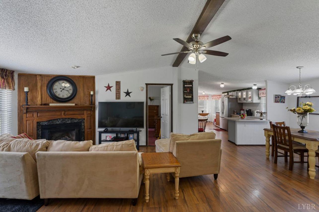 1362 Peaceful Ridge Road Huddleston, VA 24104 - Photo 5 of 19 a living room with furniture a flat screen tv and a fireplace