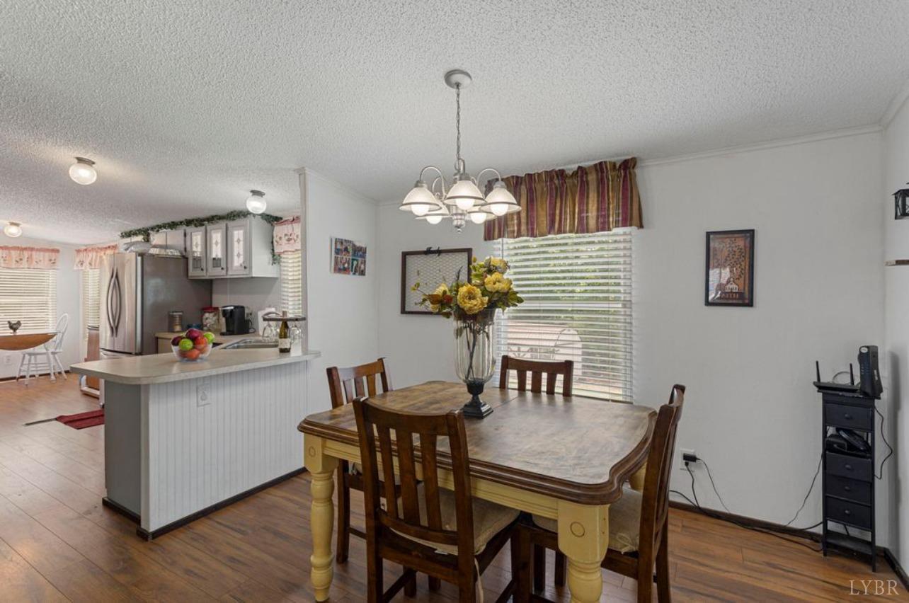 1362 Peaceful Ridge Road Huddleston, VA 24104 - Photo 6 of 19 a view of a dining room with furniture and wooden floor
