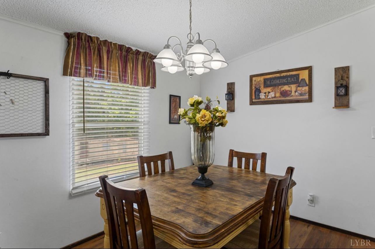 1362 Peaceful Ridge Road Huddleston, VA 24104 - Photo 7 of 19 a view of a dining room with furniture and chandelier
