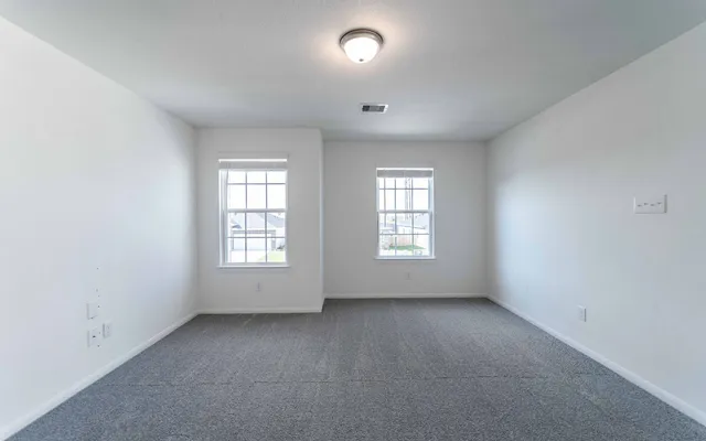an empty room with window and windows
