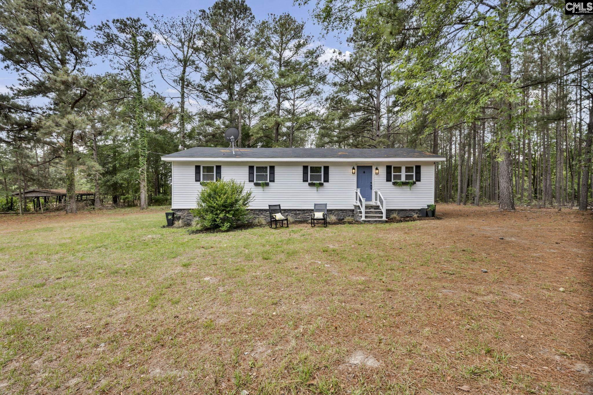 8107 Black River Road Rembert, SC 29128 - Photo 35 of 38 a front view of house with yard and trees around