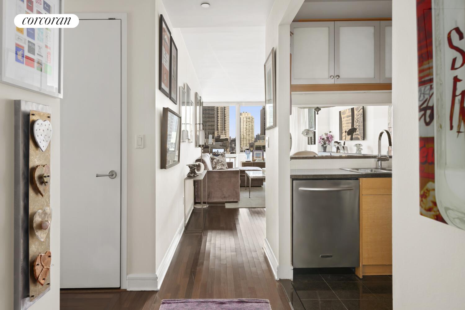 120 Riverside Boulevard, Unit PH1J Manhattan, NY 10069 - Photo 4 of 12 a kitchen with kitchen island granite countertop lots of counter top space and refrigerator