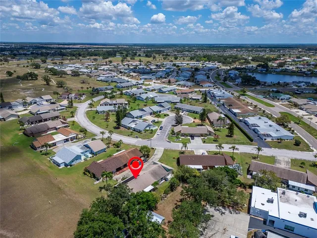 an aerial view of a house with a yard and lake view