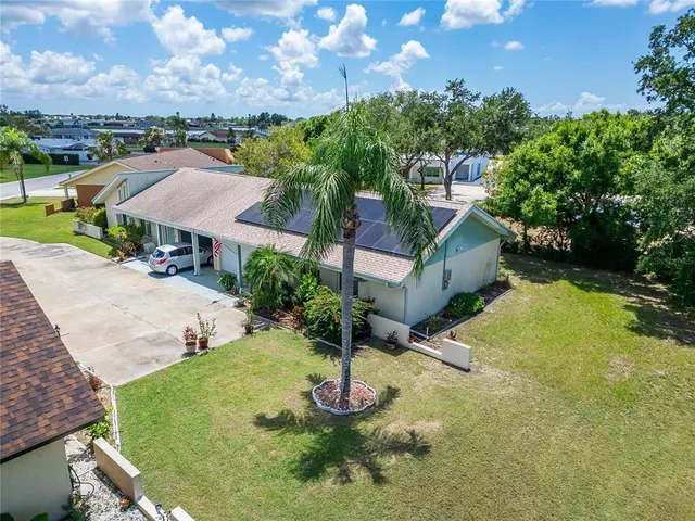 a aerial view of a house with swimming pool and a yard