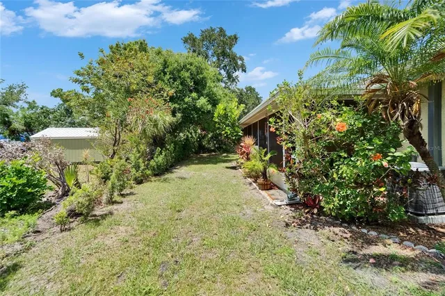 an aerial view of a house with a yard and lake view
