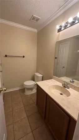 a bathroom with a sink a toilet and mirror