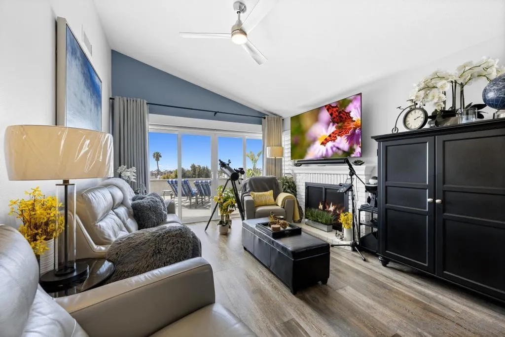 6905 Whitecap Drive Carlsbad, CA 92011 - Photo 13 of 66 a living room with fireplace furniture and a flat screen tv