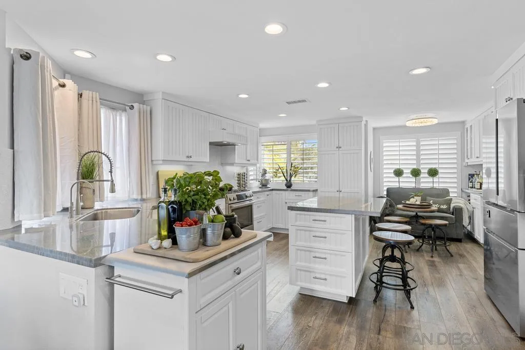 6905 Whitecap Drive Carlsbad, CA 92011 - Photo 15 of 66 a kitchen with a table chairs refrigerator and cabinets
