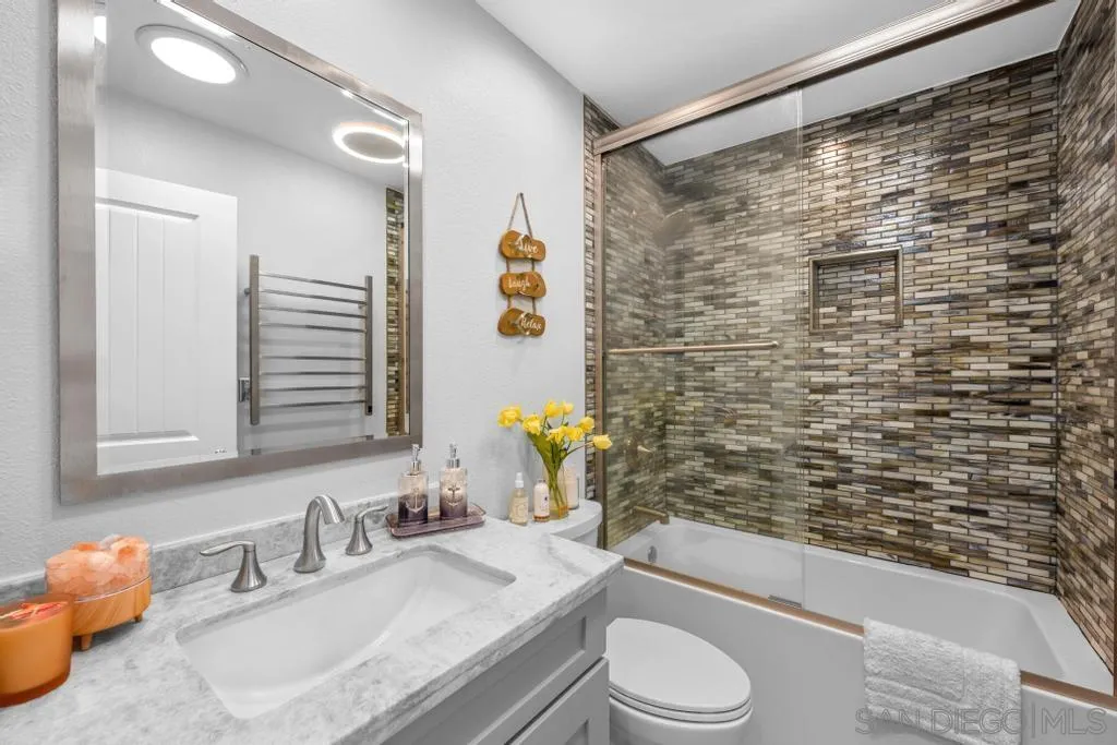 6905 Whitecap Drive Carlsbad, CA 92011 - Photo 31 of 66 a bathroom with a granite countertop sink toilet and shower