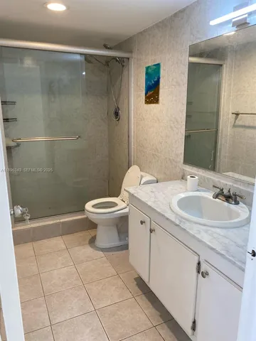 a bathroom with a sink a toilet and a shower