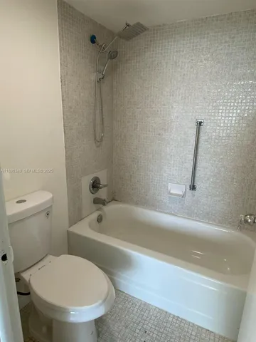 a bathroom with a toilet and a bath tub