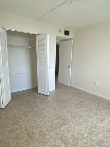 a view of an empty room and closet area