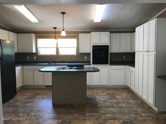 267 Red Barn Road Newport, NC 28570 - Photo 7 of 21 Lots of cabinets and island with cooktop