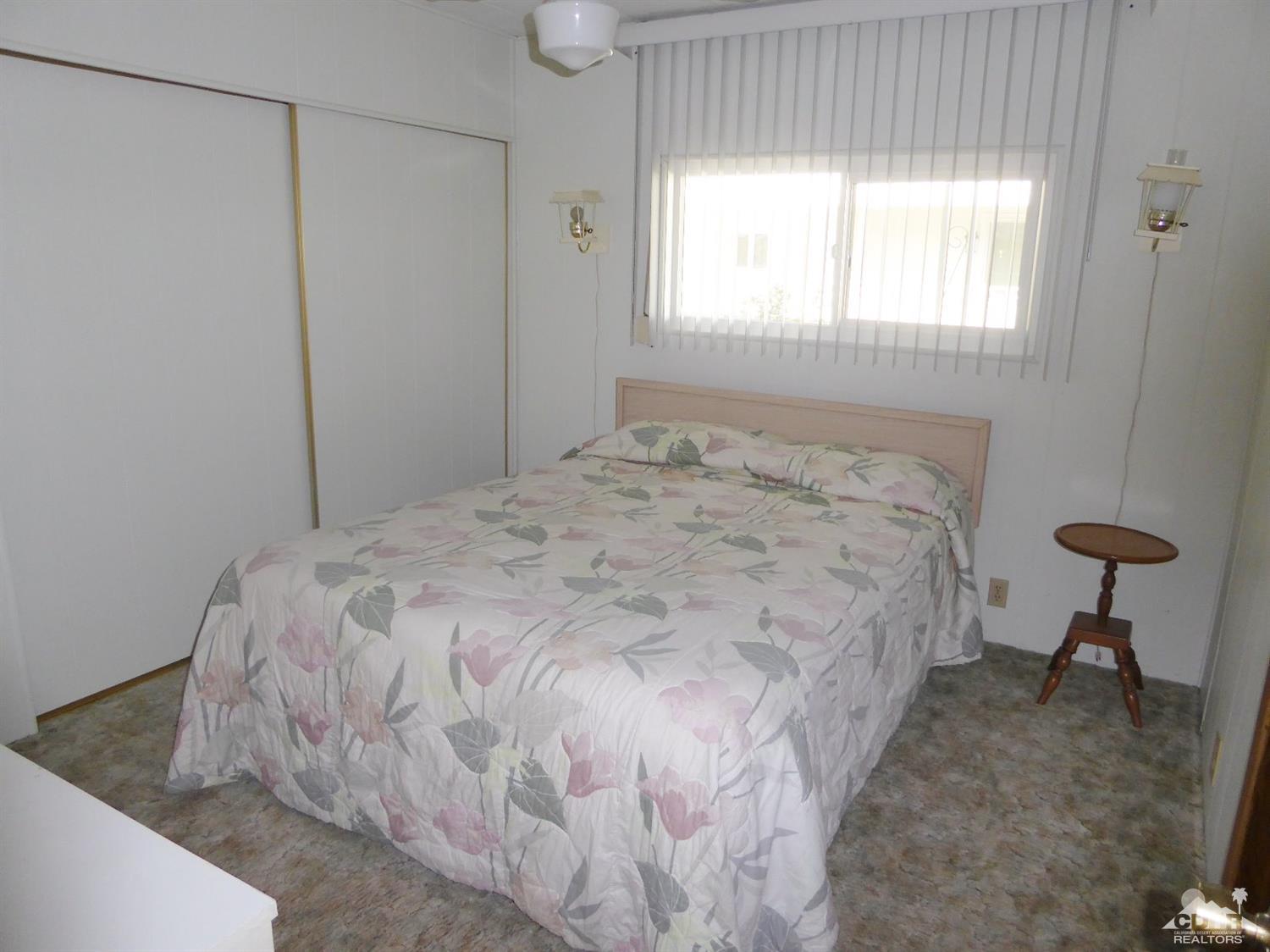 73710 Algonquin Place Thousand Palms, CA 92276 - Photo 10 of 16 a bed sitting in a bedroom next to a window