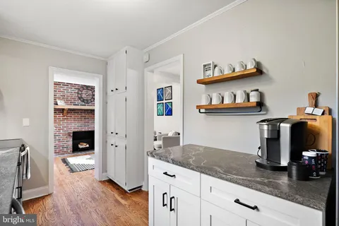 a hallway with fireplace and wooden floor