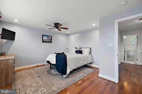 a spacious bedroom with a bed and a flat screen tv