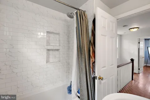 a bathroom with a shower and a glass door