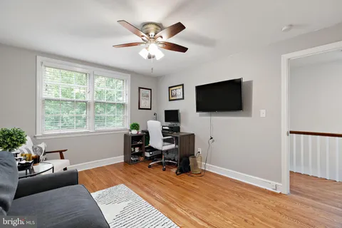 a view of a livingroom with workspace and a window