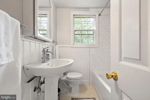 a bathroom with a sink toilet and mirror