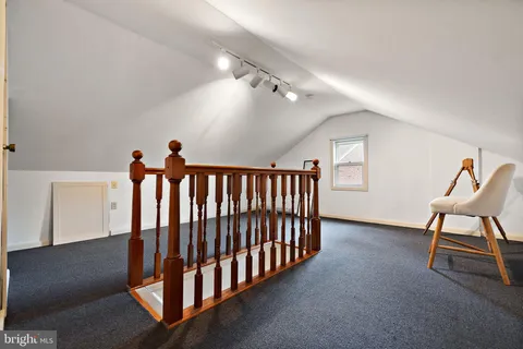 a view of a hallway with stairs and a couch