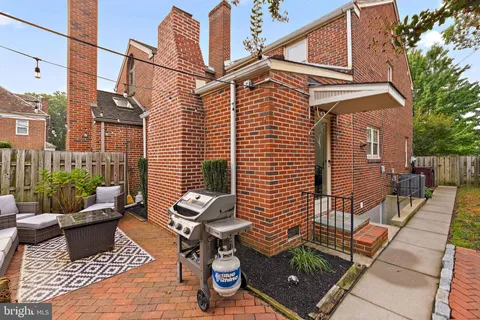 a view of a patio with a table and chairs