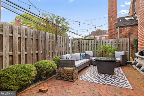 a view of a patio with couches and potted plants