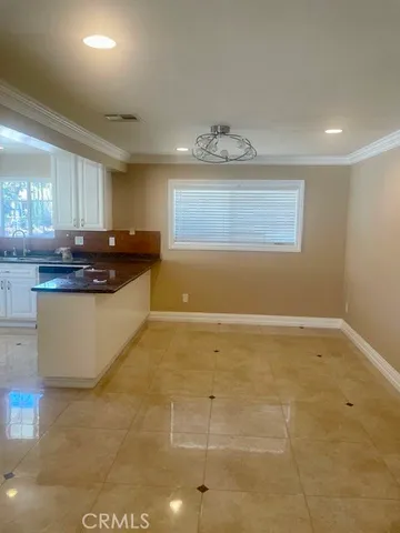 a kitchen with granite countertop a sink and cabinets