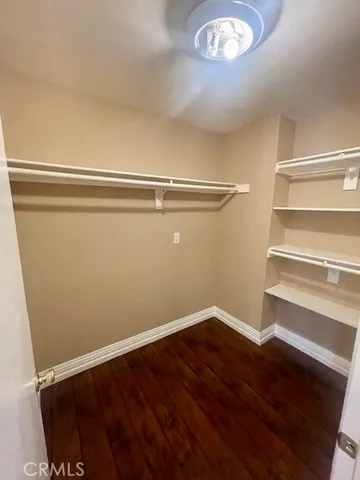 a view of a room with wooden floor and white walls