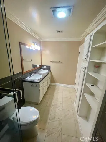 a bathroom with a sink toilet and mirror