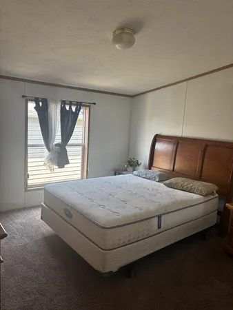a bedroom with a bed and window