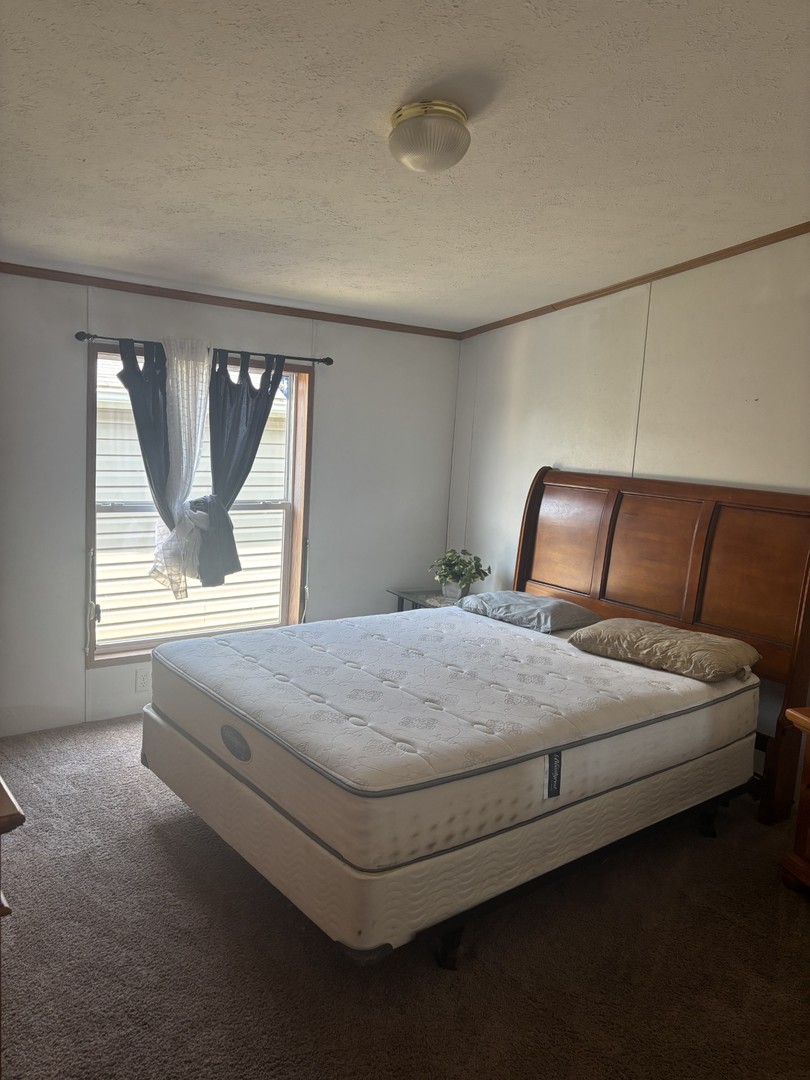 85 Partridge Lane Beecher, IL 60401 - Photo 8 of 11 a bedroom with a bed and window