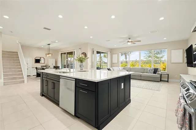 a kitchen with a stove sink and cabinets