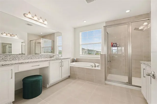 a spacious bathroom with a granite countertop sink a toilet and a shower