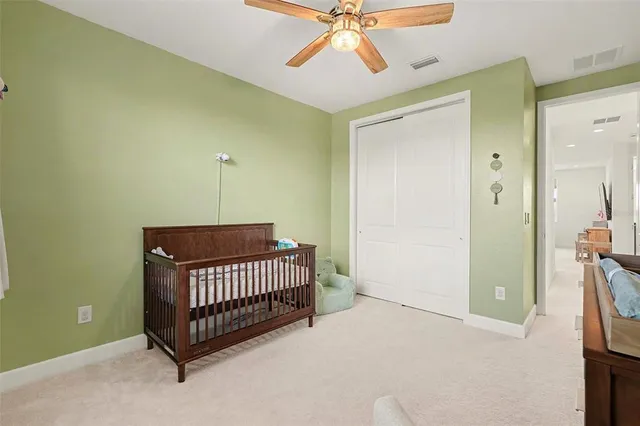 a view of a room with a chandelier fan and a window