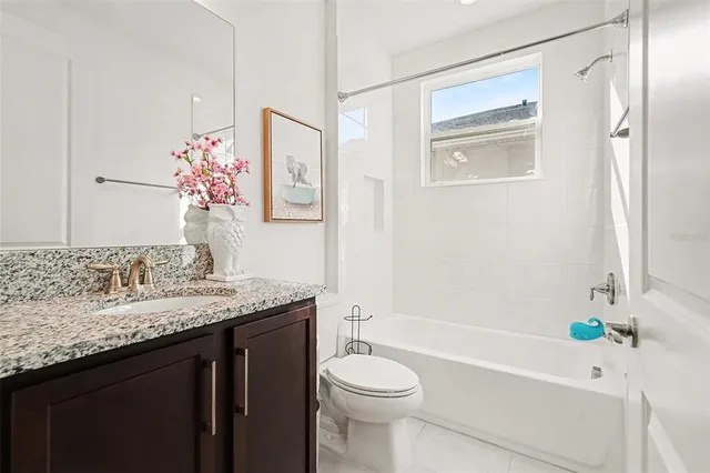 a bedroom with a bed window and a table