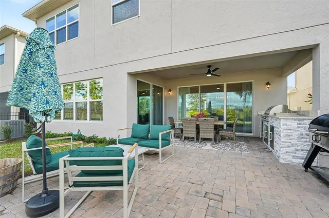 a dining room with furniture a chandelier and wooden floor