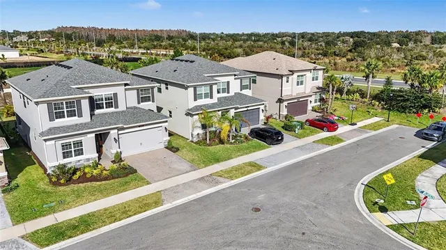an aerial view of a house with a swimming pool yard and lake view