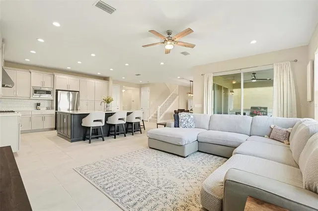 a living room with furniture kitchen view and a dining table