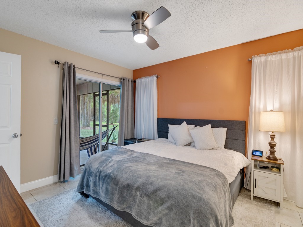 2020 Vero S Circle Southwest, Unit 4 Vero Beach, FL 32962 - Photo 11 of 28 a bedroom with a large bed and a chandelier