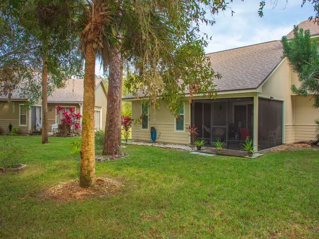 a front view of a house with a garden and plants