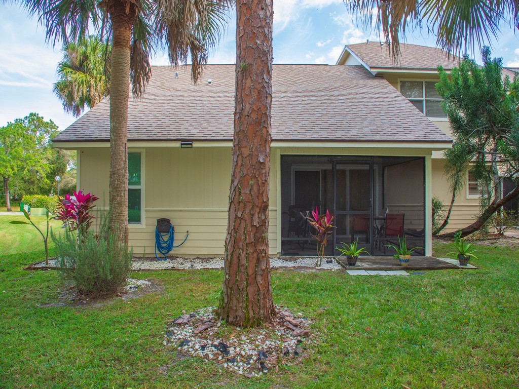 2020 Vero S Circle Southwest, Unit 4 Vero Beach, FL 32962 - Photo 21 of 28 a front view of a house with a garden and plants