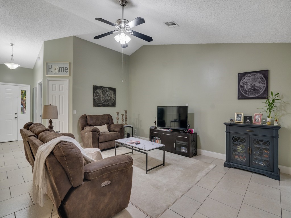 2020 Vero S Circle Southwest, Unit 4 Vero Beach, FL 32962 - Photo 7 of 28 a living room with furniture and a flat screen tv