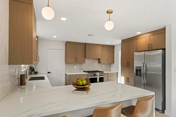 a kitchen with a refrigerator a sink and a stove