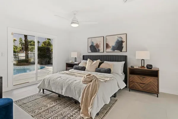 a bedroom with a bed and large window