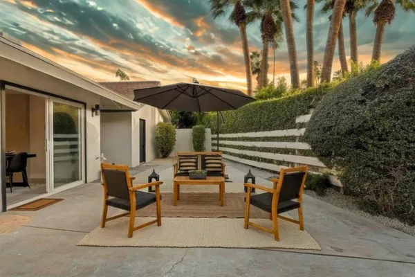 a patio with a patio table and chairs