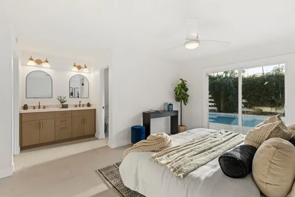 a bedroom with a bed and a large window