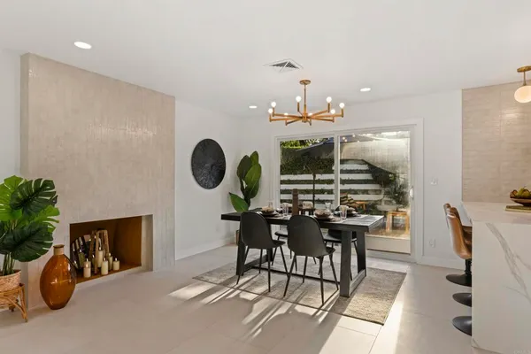 a view of a dining room with furniture and chandelier