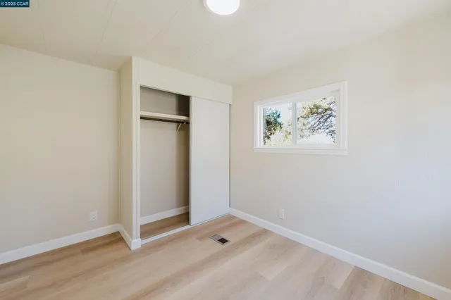 an empty room with a door and wooden floor