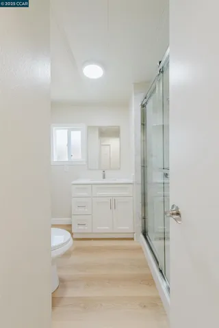 a bathroom with a tub shower vanity and a sink