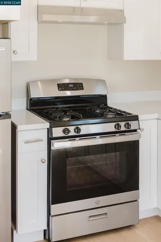 a stove top oven sitting inside of a kitchen